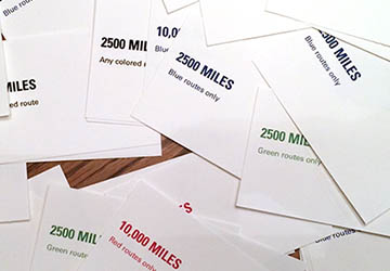 A pile of Frequent Flier game cards.
